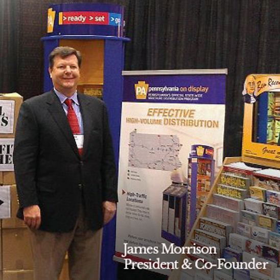 james morrison - president and co-founder of great display company standing next to some displays at a tradeshow